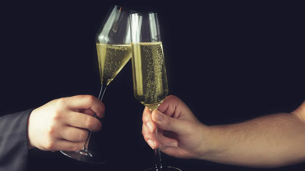 Person holding clear wine glass