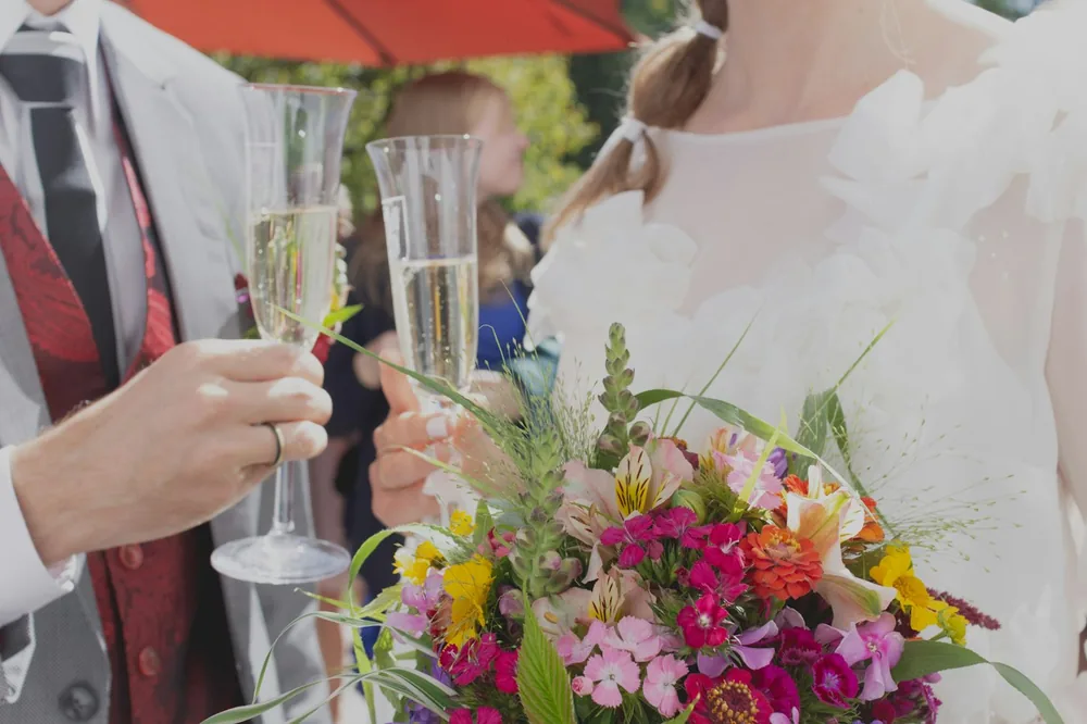 Person holding wine glasses