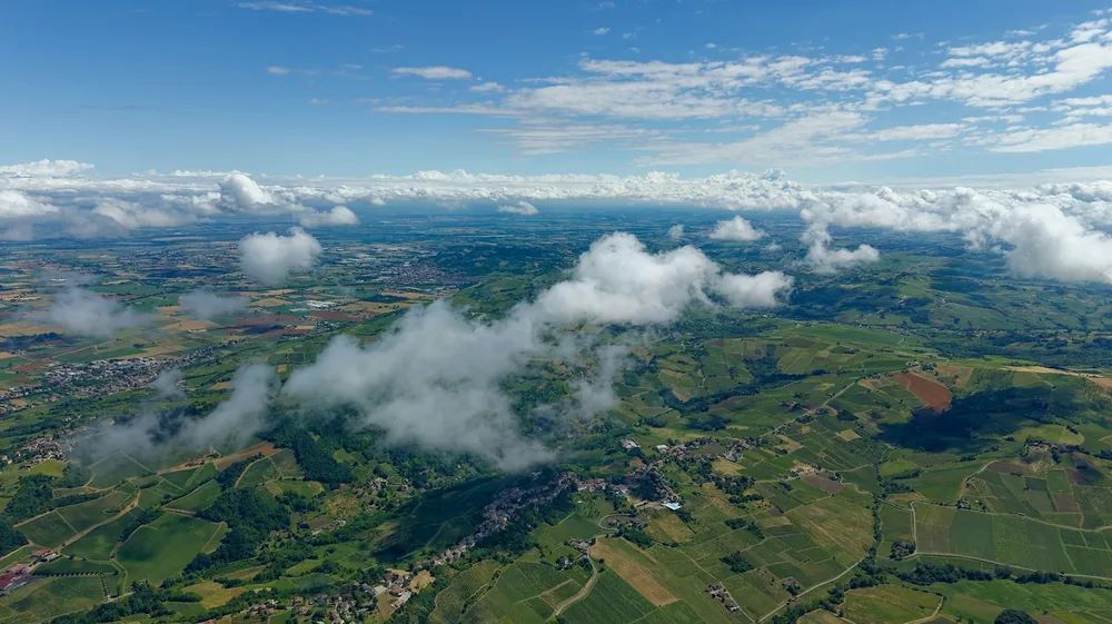 Rolling green hills and clouds from an aerial view