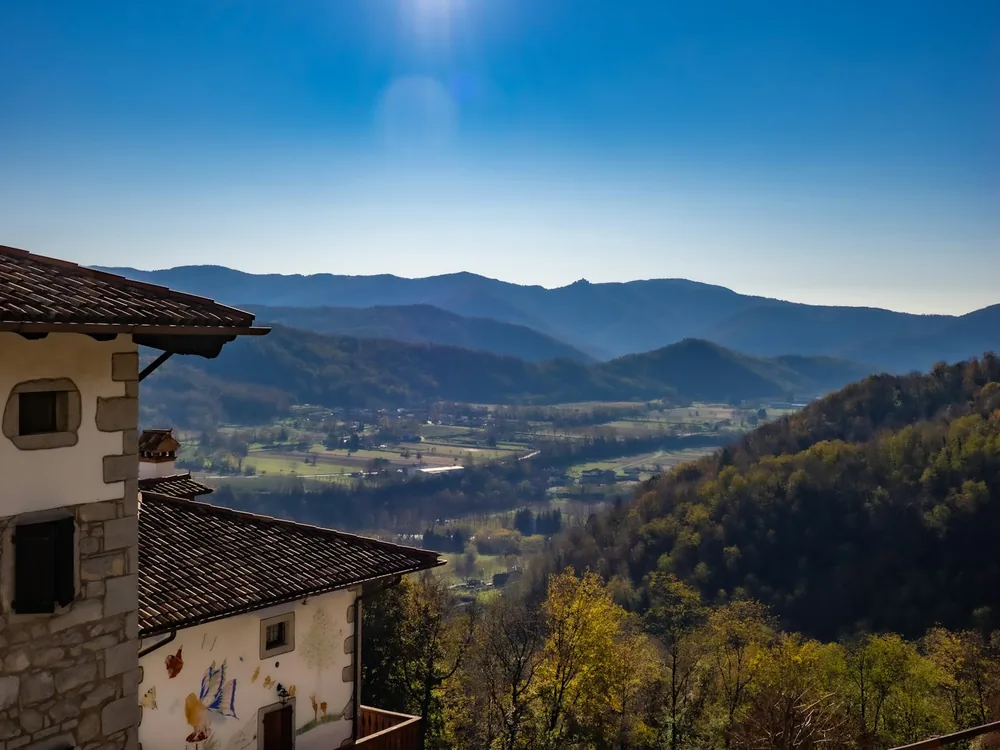Rolling hills and distant mountains from a village