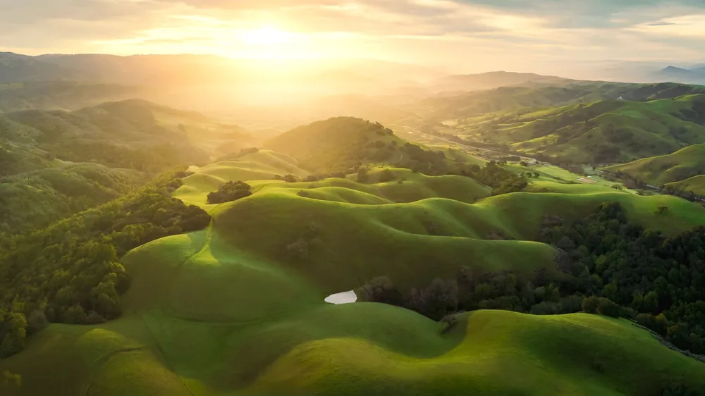 Rolling hills illuminated by sunrise light in San Jose, California