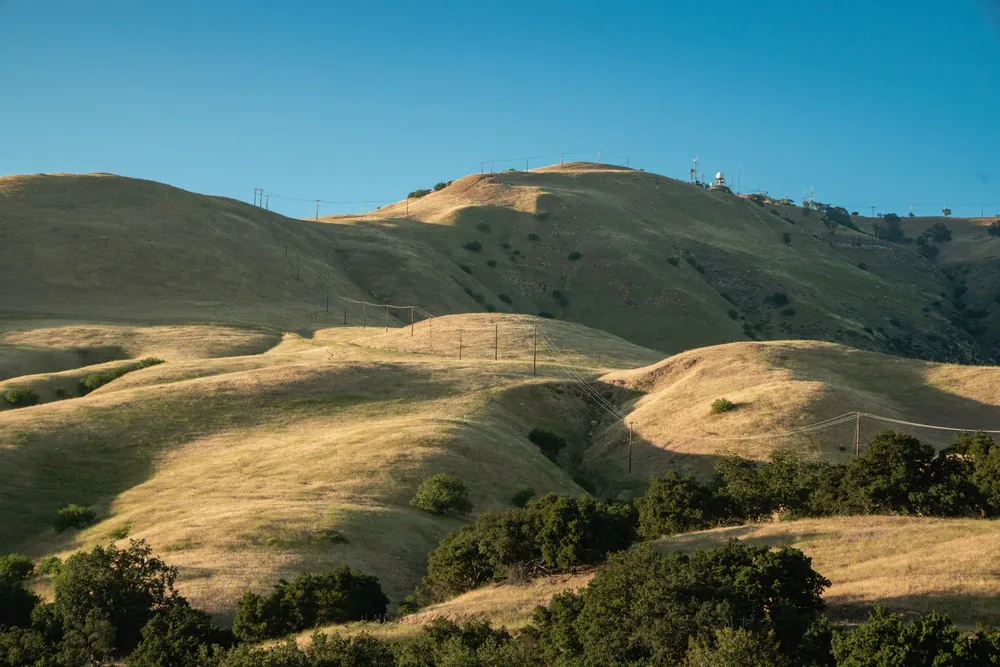 Rolling hills under a clear blue sky, showcasing natural beauty