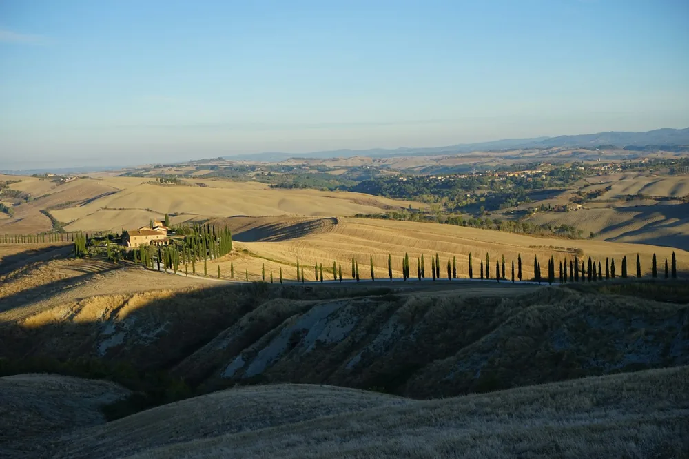 Rolling hills with a house in the distance