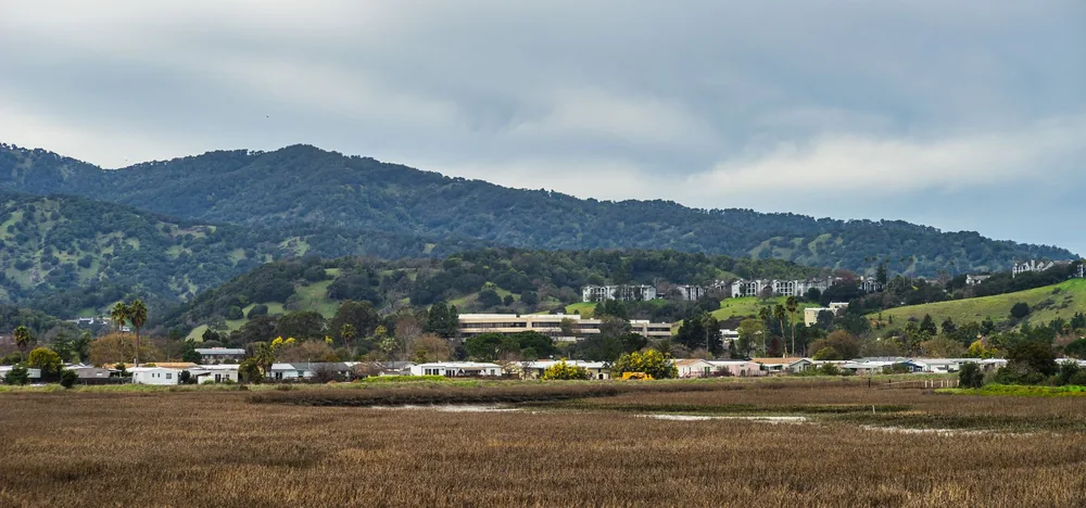 Rural landscape featuring homes nestled against rolling hills