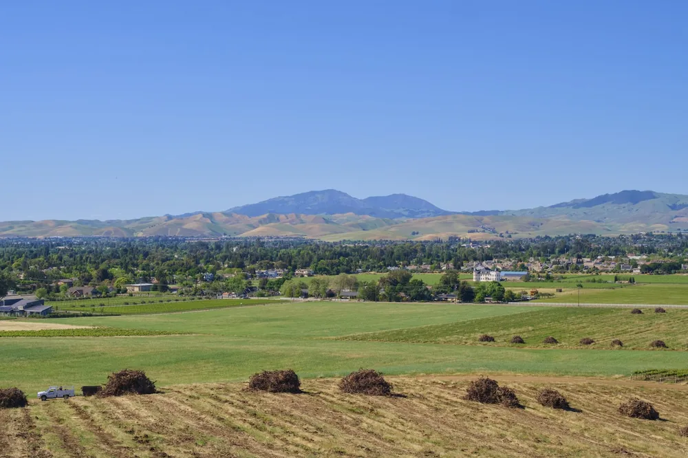 Rural landscape with rolling hills and distant mountains