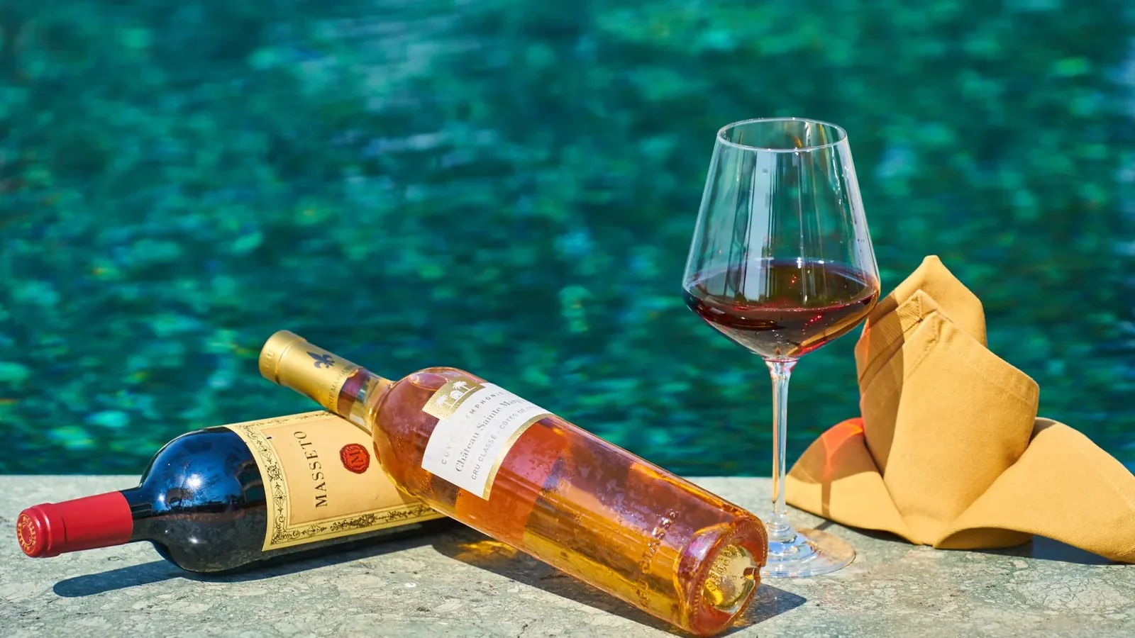 Sophisticated wine setting by the pool, perfect for relaxation and celebration