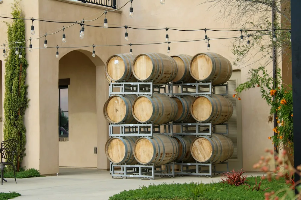 Stacked wine barrels outside a building