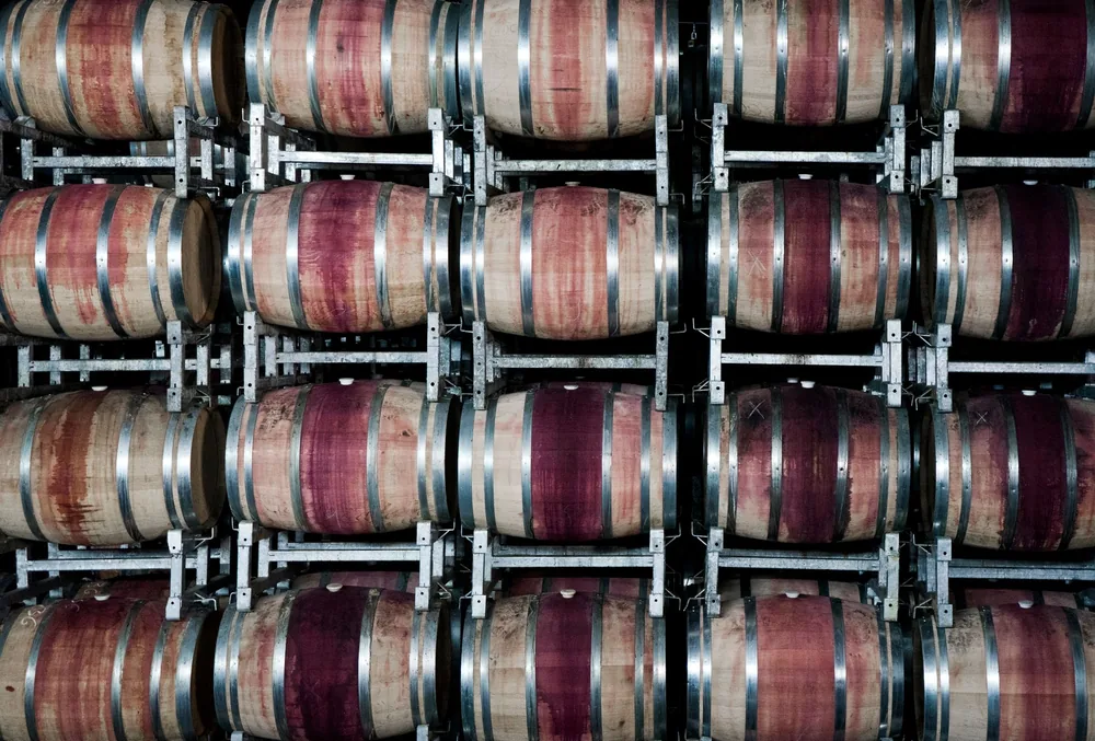 Stacked wooden barrels in a winery store wine, highlighting the art of winemaking
