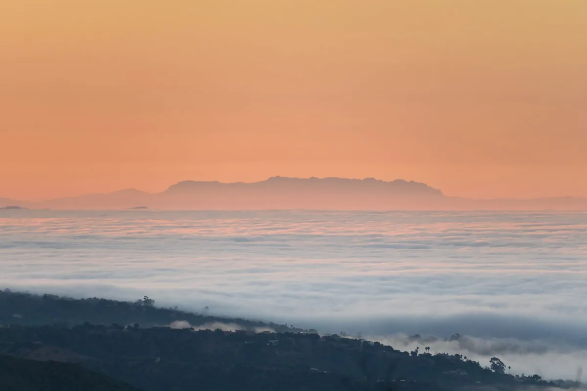 Sunrise over clouds in Santa Barbara, creating a serene and warm atmosphere