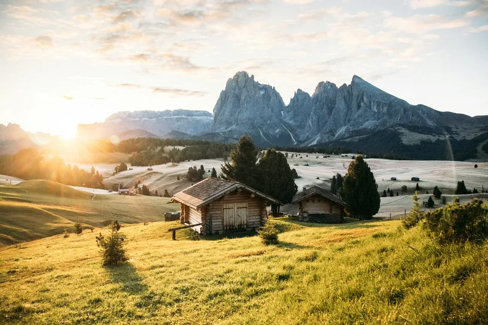 Sunrise over mountain landscape with traditional wooden cabins
