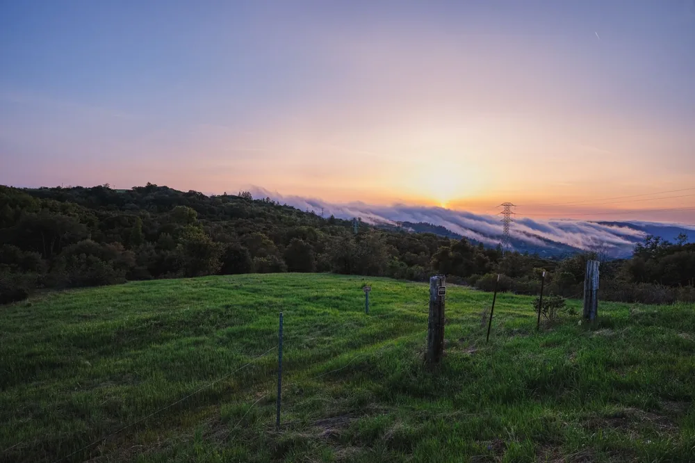 Sunset over green hills and distant clouds in Palo Alto, CA. Perfect for landscape lovers