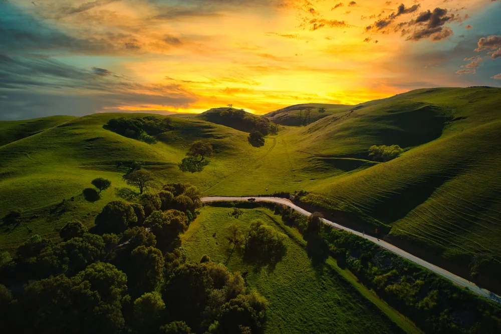 The rolling hills in Sunol, California at sunset with vivid colors and lush landscapes