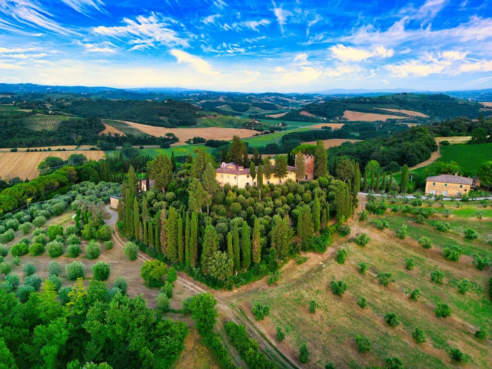 Tuscan landscape with a historic villa and olive groves