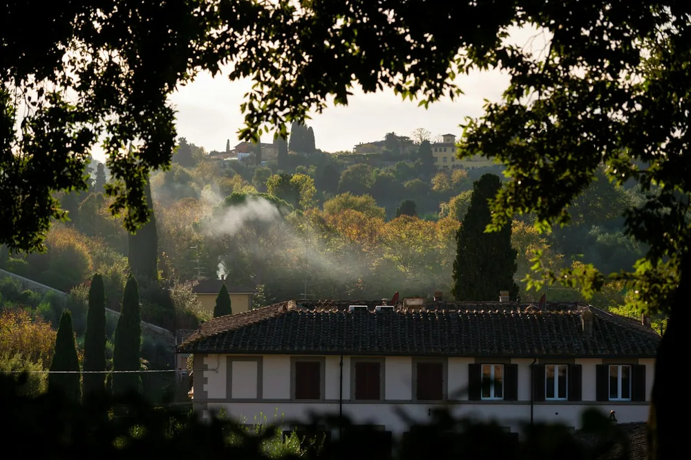 Tuscan villa with rolling hills and distant town