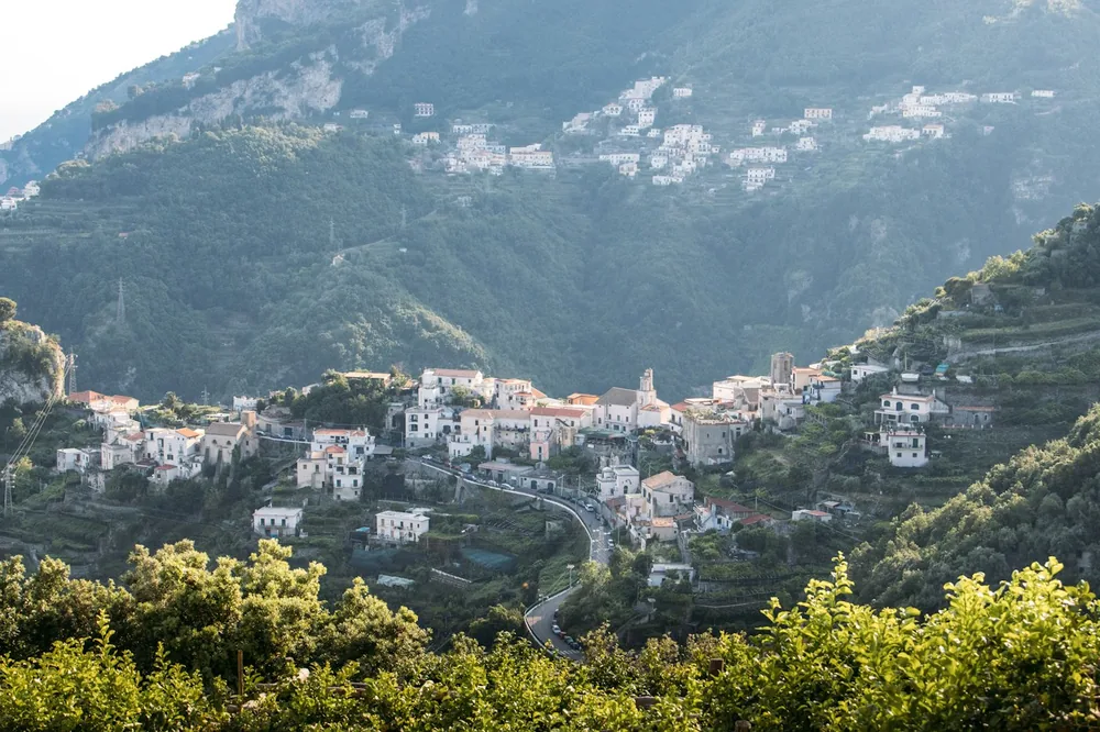 Village among green mountains and terraced hillsides