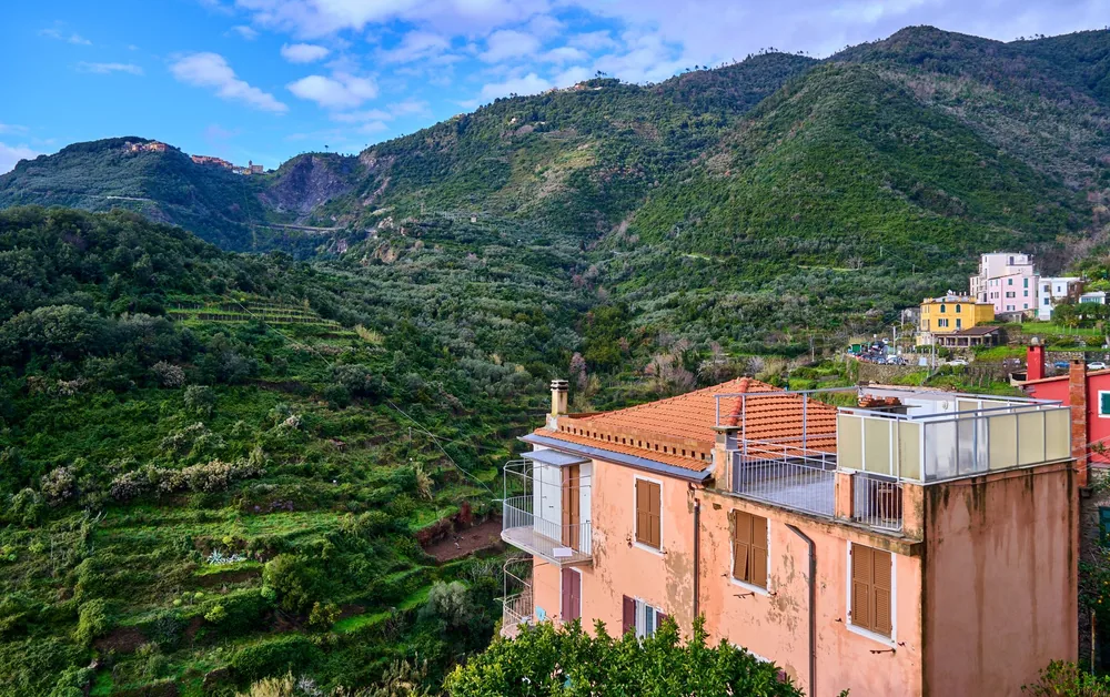 Village nestled in a lush green valley with architecture and scenic hills