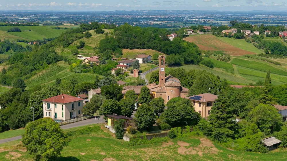 Village with a church nestled among green hills