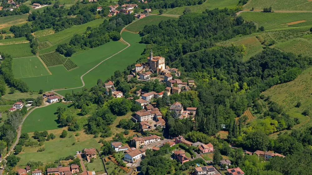 Village with church tower surrounded by green fields
