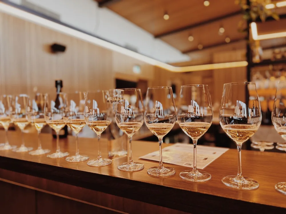 White wine tasting setup with glasses lined up on a bar counter, perfect for events