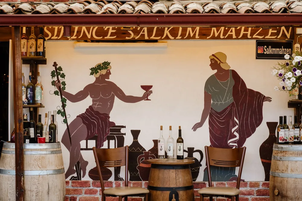 Wine bar featuring classical-inspired artwork and rustic wooden decor