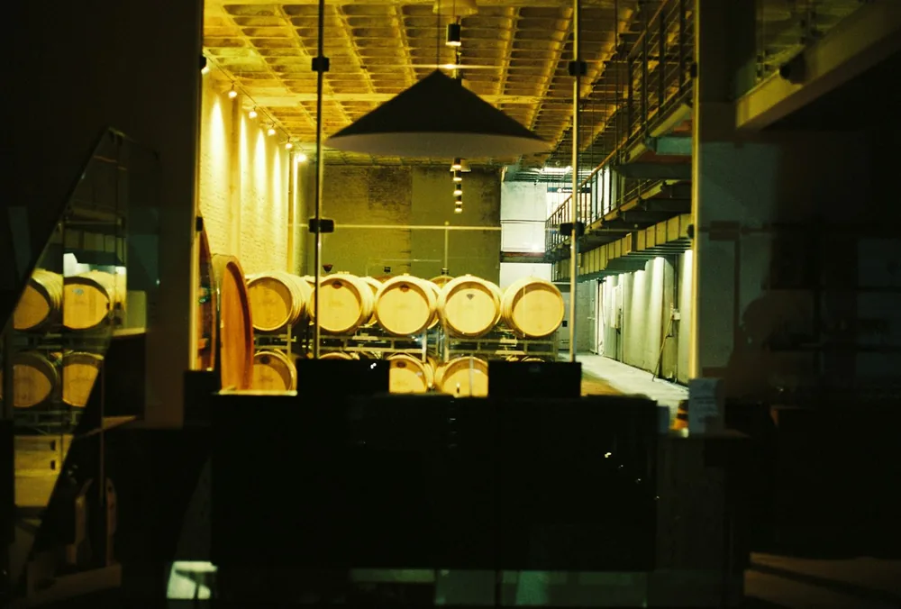 Wine barrels stored in a dimly lit cellar