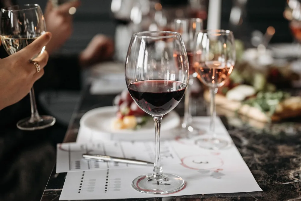 Wine glasses on a table during an elegant wine tasting event with friends