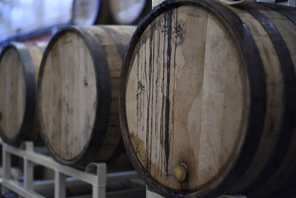 Wooden wine barrels used for fermentation and storage in a winery cellar